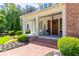Close-up of the charming front porch with a double-door entrance, white rocking chairs, and flower pot decor at 101 Morgan Ln, Canton, GA 30115