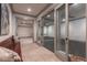 View of the entry to a home gym with mirrored wall and workout space beyond glass doors at 101 Morgan Ln, Canton, GA 30115
