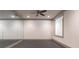Home gym with mirrored wall, ceiling fan, and natural light, ideal for workouts at 101 Morgan Ln, Canton, GA 30115