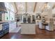 Spacious kitchen with island, rustic cabinets, professional range, and open shelving with exposed beams at 101 Morgan Ln, Canton, GA 30115