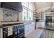 Charming kitchen with black island, rustic cabinets, professional range, and open shelving at 101 Morgan Ln, Canton, GA 30115