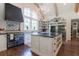 Charming kitchen with black island, rustic cabinets, professional range, and open shelving at 101 Morgan Ln, Canton, GA 30115