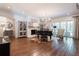 Elegant living room featuring a grand piano, decorative fireplace, and hardwood floors at 101 Morgan Ln, Canton, GA 30115