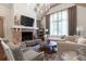 Bright living room features vaulted ceilings, fireplace with brick surround, two sofas, chairs and a round wood coffee table at 101 Morgan Ln, Canton, GA 30115