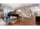 Open living area with a piano, elegant chandelier, and staircase, creating a grand and inviting atmosphere at 101 Morgan Ln, Canton, GA 30115