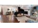 Stylish living room with hardwood floors, fireplace and grand piano at 101 Morgan Ln, Canton, GA 30115