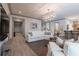 Inviting living room with two white sofas, modern lighting, and light wood-look flooring at 101 Morgan Ln, Canton, GA 30115
