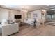 Bright living room features white sofas, hardwood floors, and a decorative chandelier at 101 Morgan Ln, Canton, GA 30115
