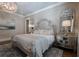 Main bedroom featuring an ornate headboard, decorative mirrors, and hardwood flooring at 101 Morgan Ln, Canton, GA 30115