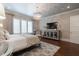 Main bedroom features a chandelier, television, and large windows providing plenty of natural light at 101 Morgan Ln, Canton, GA 30115