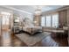 Main bedroom featuring decorative mirrors, a chandelier, and hardwood flooring at 101 Morgan Ln, Canton, GA 30115