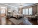 Elegant bedroom with chandelier, hardwood floors, decorative mirrors, and neutral tones at 101 Morgan Ln, Canton, GA 30115