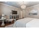 Main bedroom featuring hardwood floors, a crystal chandelier, accent chair, and an ensuite bathroom at 101 Morgan Ln, Canton, GA 30115