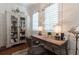 Cozy office with natural light, custom cabinet and shelving, and hardwood floors at 101 Morgan Ln, Canton, GA 30115