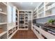 Walk-in pantry featuring custom shelving, countertops, built in microwave and stainless steel refrigerator at 101 Morgan Ln, Canton, GA 30115