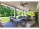 Spacious covered patio with ample seating, ceiling fans, and a view of the landscaped backyard at 101 Morgan Ln, Canton, GA 30115