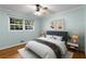 Bright bedroom with a large window, hardwood floors, light blue walls and modern decor at 1901 Trophy Dr, Marietta, GA 30062