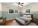 Cozy bedroom featuring hardwood floors, two-tone walls, and natural light from large windows at 1901 Trophy Dr, Marietta, GA 30062