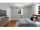 Cozy bedroom features neutral paint, a window with natural light, and dresser with wall-mounted television at 1901 Trophy Dr, Marietta, GA 30062