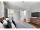 Bright bedroom with an open ensuite bathroom boasts hardwood floors, modern furnishings, and TV at 1901 Trophy Dr, Marietta, GA 30062