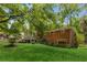 Charming brick home with lush landscaping, mature trees, and a rear deck overlooking the serene backyard at 1901 Trophy Dr, Marietta, GA 30062
