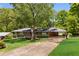 Traditional brick home with well-manicured lawn and landscaping, features a covered carport at 1901 Trophy Dr, Marietta, GA 30062