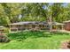 Charming brick ranch home with mature landscaping and a covered carport at 1901 Trophy Dr, Marietta, GA 30062