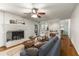 Inviting living room with fireplace, hardwood flooring, ceiling fan and view into kitchen area at 1901 Trophy Dr, Marietta, GA 30062