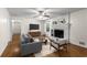 Bright living room with hardwood floors, white brick fireplace, ceiling fan and comfortable seating arrangement at 1901 Trophy Dr, Marietta, GA 30062