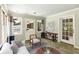 Bright sunroom with multiple windows, neutral decor, stylish lighting, and access to the deck at 1901 Trophy Dr, Marietta, GA 30062