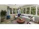 Light-filled sunroom featuring multiple windows with tree views, comfortable seating, and stylish decor at 1901 Trophy Dr, Marietta, GA 30062