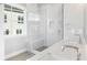 Modern bathroom featuring a clear glass shower, double sink with a quartz countertop, and sleek chrome fixtures at 2035 Parkside Ln, Roswell, GA 30076