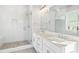 Modern bathroom with double sinks, quartz countertops, large mirror, and glass-enclosed shower stall at 2035 Parkside Ln, Roswell, GA 30076