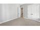 This is a spacious bedroom features neutral walls and carpeted floors with a double closet for storage at 2035 Parkside Ln, Roswell, GA 30076