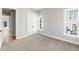 Neutral bedroom featuring carpeted floors, complemented by white trim and double closets for ample storage space at 2035 Parkside Ln, Roswell, GA 30076
