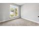 A cozy bedroom space with a large window offers a view of the outdoors and lets in natural light at 2035 Parkside Ln, Roswell, GA 30076