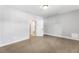 A light filled primary bedroom with a view into an attached bathroom at 2035 Parkside Ln, Roswell, GA 30076