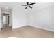 Bedroom features hardwood floors, ceiling fan, and an open doorway with modern paint at 2035 Parkside Ln, Roswell, GA 30076
