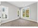 Bright bedroom with large windows offering views of the surrounding neighborhood and lush greenery at 2035 Parkside Ln, Roswell, GA 30076