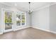 Bright dining room with hardwood floors, modern chandelier, and large window overlooking the outdoor views at 2035 Parkside Ln, Roswell, GA 30076