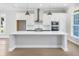 Modern kitchen with white countertops, stainless steel appliances, and ample cabinet space at 2035 Parkside Ln, Roswell, GA 30076