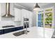 Modern kitchen with white cabinets, stainless steel appliances, and a large island with bar seating at 2035 Parkside Ln, Roswell, GA 30076