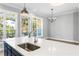 Kitchen island with a sink and faucet, with views of the dining area and exterior windows at 2035 Parkside Ln, Roswell, GA 30076