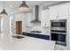 Close-up of a modern kitchen with stainless steel appliances, quartz countertops, and a center island at 2035 Parkside Ln, Roswell, GA 30076