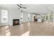 Bright, open-concept living room with a fireplace, hardwood floors, and large windows leading to the kitchen at 2035 Parkside Ln, Roswell, GA 30076