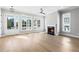 Bright living room with hardwood floors, fireplace, and large windows to let in natural light at 2035 Parkside Ln, Roswell, GA 30076