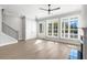 Contemporary living room with large windows, hardwood floors, a black fireplace, and access to the outdoor porch at 2035 Parkside Ln, Roswell, GA 30076