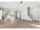 Spacious living area with hardwood floors, recessed lighting, and staircase access creating an inviting atmosphere at 2035 Parkside Ln, Roswell, GA 30076