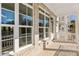 Stylish covered porch featuring brick detail, white railings, and large windows for relaxing outdoor living at 2035 Parkside Ln, Roswell, GA 30076