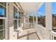 Inviting covered porch with brick flooring, white columns, and ample natural light, creating an outdoor oasis at 2035 Parkside Ln, Roswell, GA 30076
